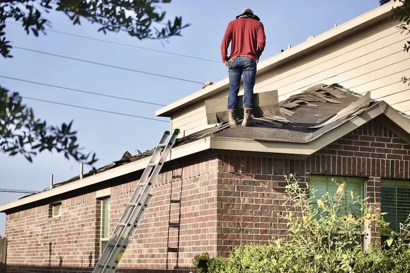 Professional roofer working on a residential roof in Andersonville